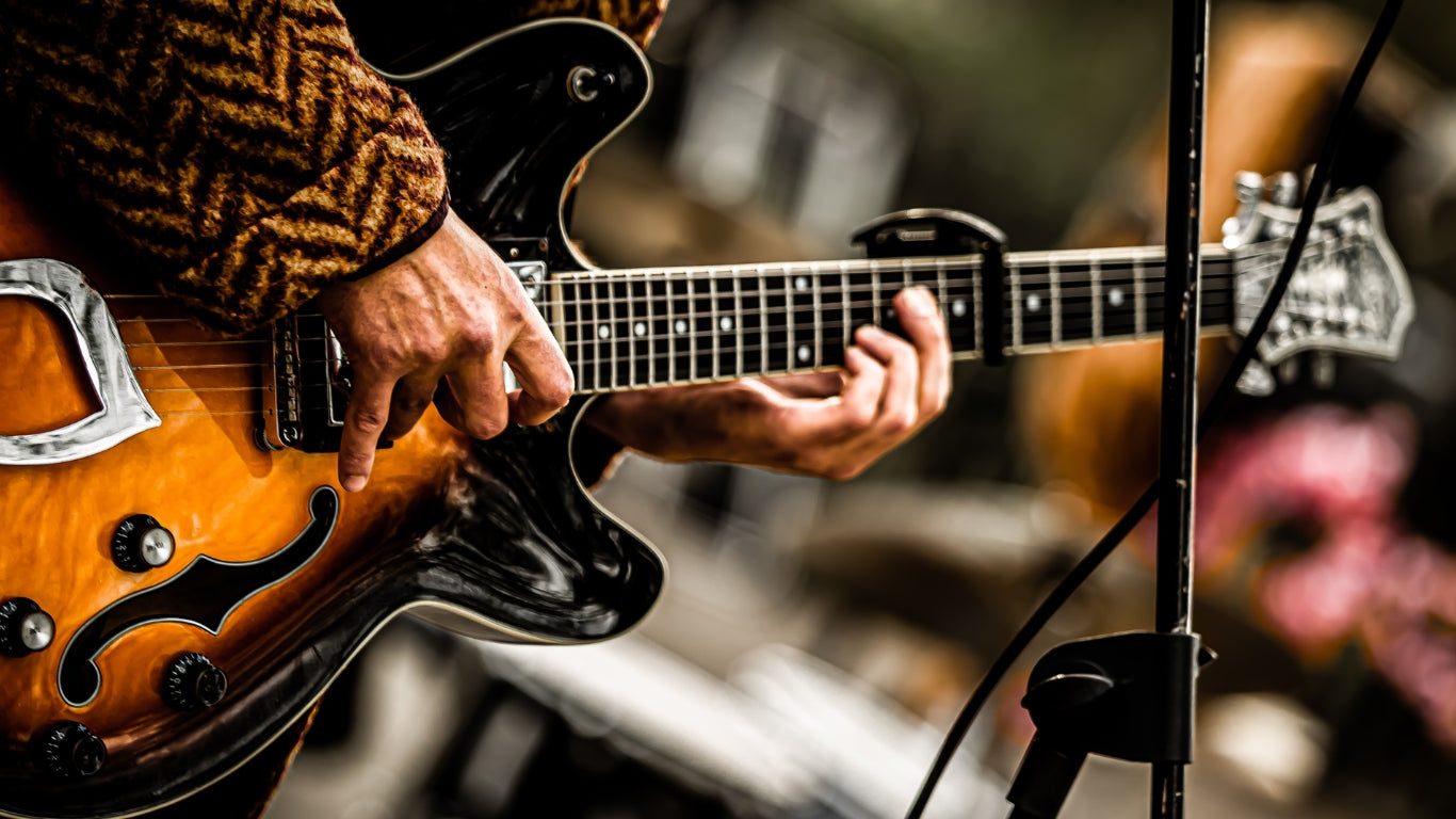 Close-up of an electric guitar being played live, highlighting the diversity and craftsmanship and beauty in the Electric Guitars.